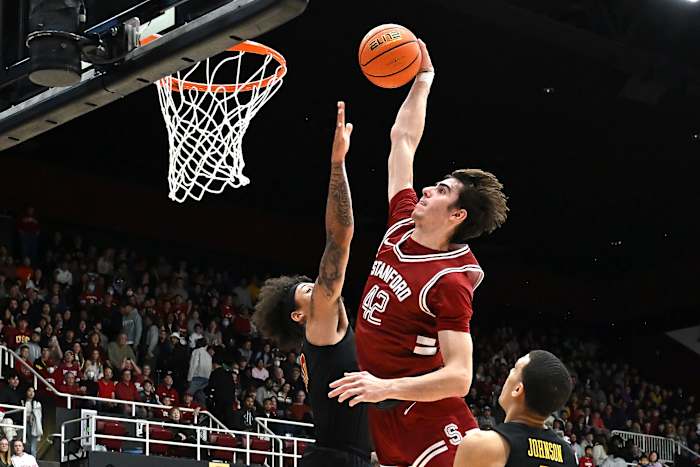 Feb 10, 2024; Stanford, California, USA; Stanford Cardinal forward Maxime Raynaud (42) dunks the ball against USC Trojans forward DJ Rodman (10) during the first half at Maples Pavilion. Mandatory Credit: Robert Edwards-USA TODAY Sports
